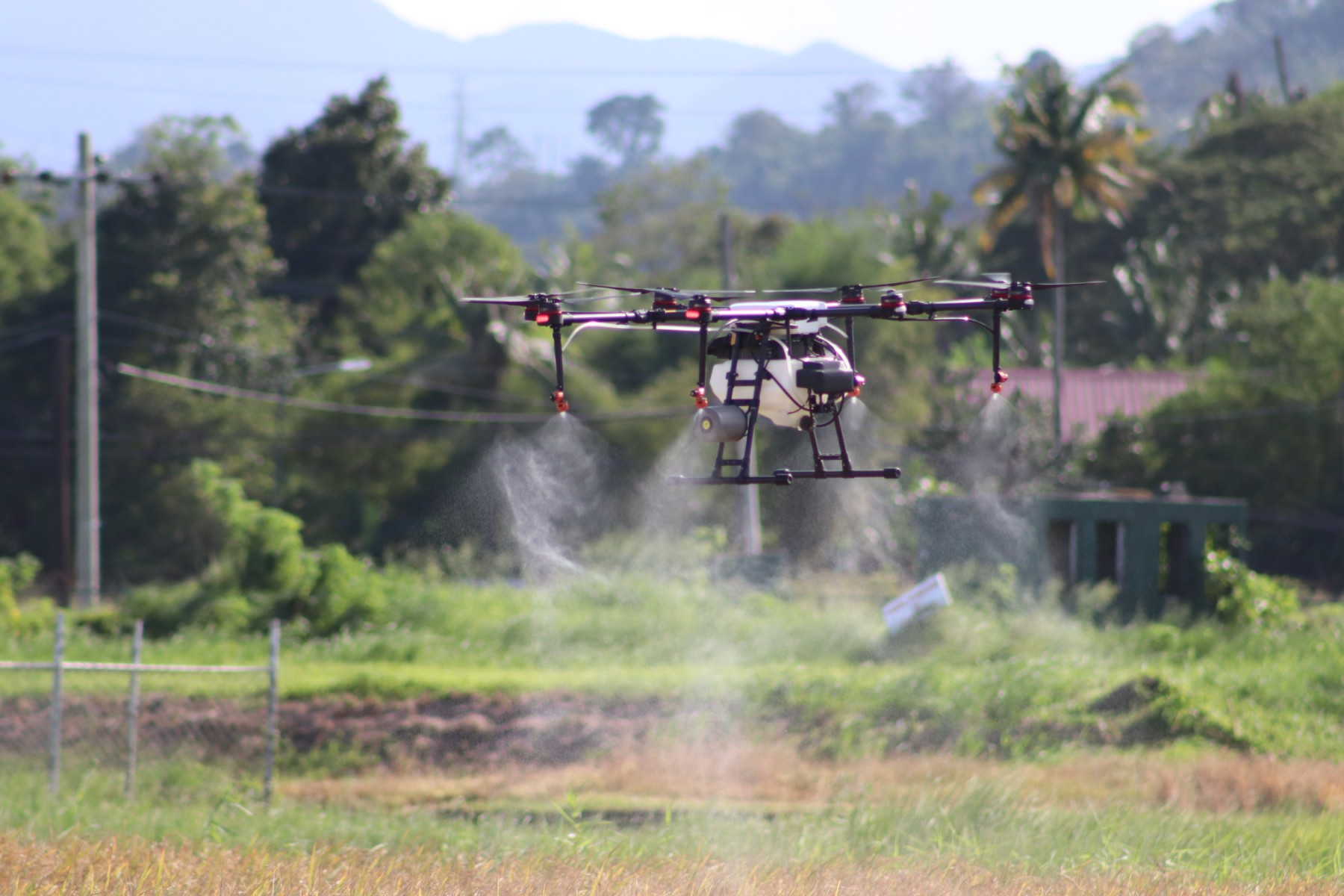 Agricultural drone spraying a field